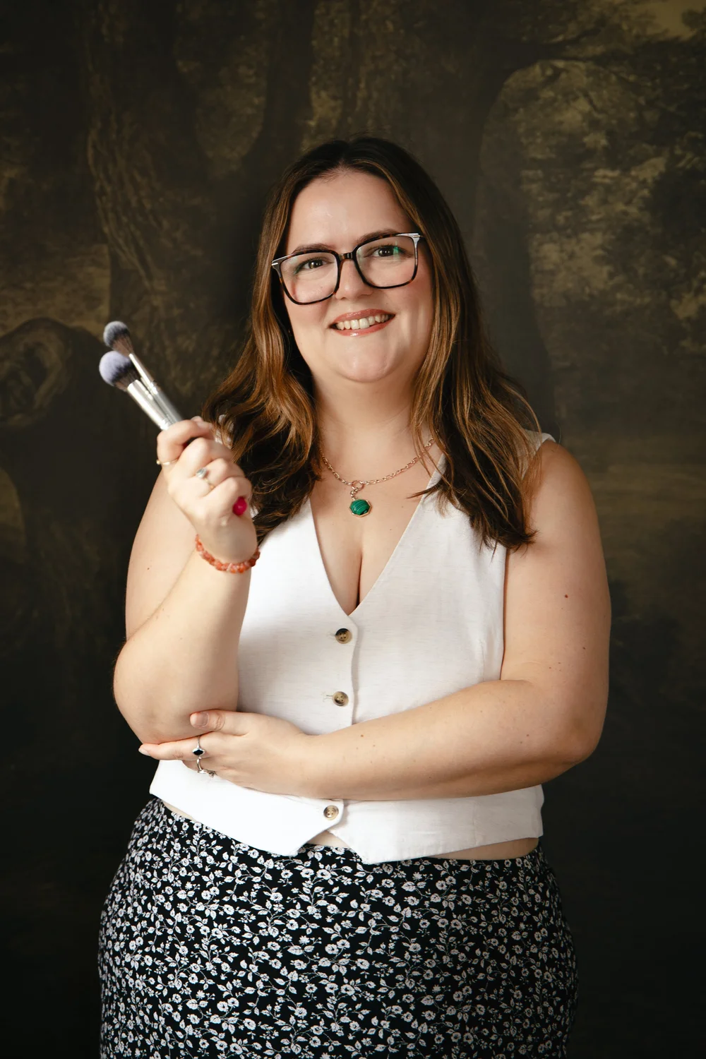 Vicky Jiggens smiling with her makeup brushes